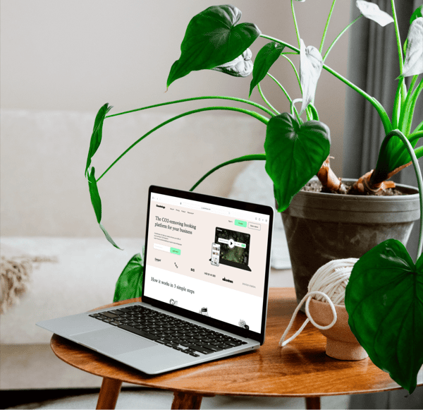 MacBook mockup on a wooden table with flower pot (Mockuuups Studio)-1